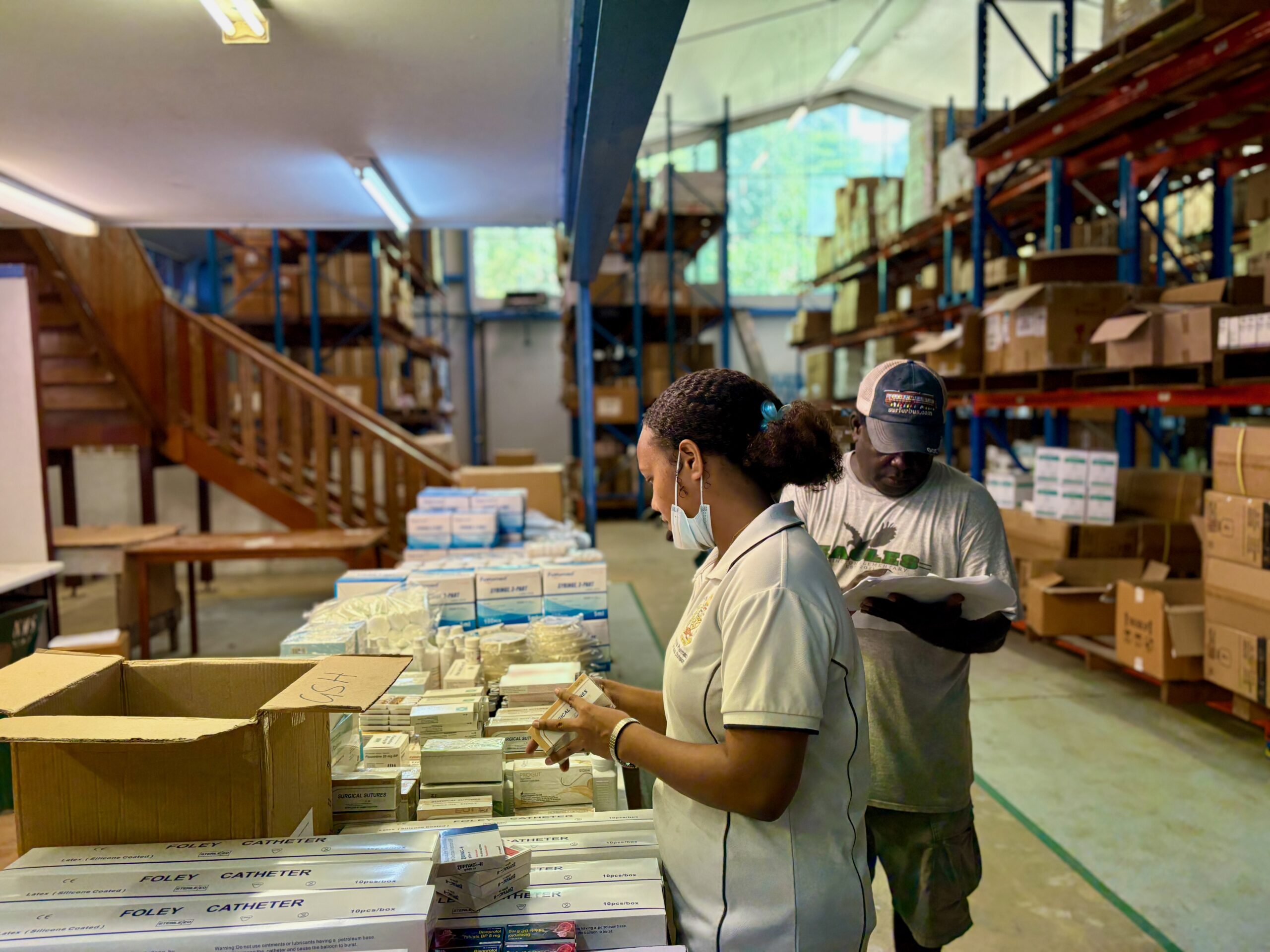 Jefferson, Warehouse Supervisor and Lilian Warehouse Assistant packing medicine at NMS, Honiara, Solomon Islands Jefferson, Warehouse Supervisor and Lilian Warehouse Assistant packing medicine at NMS, Honiara, Solomon Islands